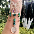 Silver butterfly suncatcher with green crystals and moon pendant held in hand - Green Agate