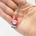 Detailed close-up of a mini 2.5cm Santa Claus keychain charm held in hand - Santa Claus Style B