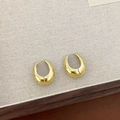 Polished golden teardrop earrings with a thick hoop design on neutral fabric - Gold Oval Ear Buckle