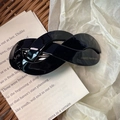 Detail of a handmade black twisted acetate hair clip showing the France Handmade gold stamp - Black