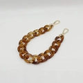Detail of tortoiseshell acrylic chain strap with gold lobster clasps on white background - Transparent Coffee