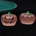 Detailed macro view of 3D luminous resin pumpkin figurines with jack-o'-lantern faces - Luminous-Squint-Pink Pumpkin Black Eyes