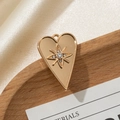 Golden heart pendant with starburst engraving and white rhinestone on silk - Solid Heart Design