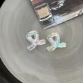 Set of two 2cm mini iridescent resin hair claws with a stylish twisted loop design - Twist Loop