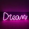 Pink LED Dream neon sign glowing on stone surface for stylish room and party decor - Battery and USB Dual Use / Pink