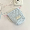 Quilted light blue drawstring storage pouch for Polaroid camera in a lifestyle setting - Gourd Pattern Light Blue