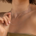 Close-up of minimalist silver snake bone chain necklace worn by a model - Gold Thread Chain Silver