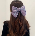 Elegant large purple iridescent fabric bow hair clip worn on model's hair - Purple Iridescent Bow Clip