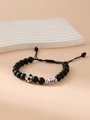 Matte black bead bracelet featuring a silver football charm and white letter H bead - Letter H