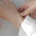 Elegant gold-tone double-layered bracelet featuring hollow heart and bead chain design - Gold