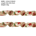 Detail of 6.5cm wide burlap Christmas ribbon with gnome print and red floral patterns - Khaki Gnome / 10m
