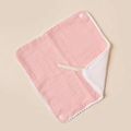 Detail of pink cotton gauze baby bib with white pom-pom trim and snap button closure - Pink And White
