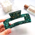 Deep green marble acetate hair claw clip with rectangular hollow design in hand - Gem Green 13cm