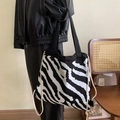 Detail of zebra-patterned knit tote bag with black strap and drawstring closure - Zebra Print Design / Black White Zebra