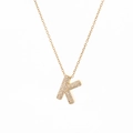 Detail of gold K-letter pendant with micro-paved white zircons on a delicate chain - Letter K