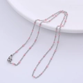 Detail of silver chain necklace with pink beads and lobster clasp on white plate - Steel - Pink Beads