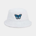 Close-up of fluffy white faux fur bucket hat with blue butterfly embroidery detail - White