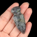Handcarved labradorite stone arrowhead with iridescent luster held in hand - Labradorite