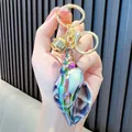 Iridescent purple and blue conch shell keychain with gold ring and small bell - Black