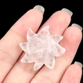 Hand-held natural rose quartz stone carved in sun shape with clear mineral textures - White Crystal