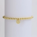 Detailed macro view of gold beaded bracelet featuring a round letter H alphabet pendant - Letter H (DB240603-H)