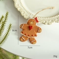 Gingerbread girl Christmas ornament with red heart and bow on white plate - Heart Gingerbread Man