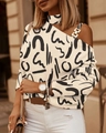 Detail of off-shoulder blouse with chain strap, gold buckle and black abstract print - S / Tops / Beige Letters