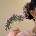 Detailed view of a gold fan-shaped hair pin with purple dried baby's breath flowers - Purple Hair Stick Earrings Set