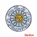 Close-up of a 9cm embroidered sun and moon patch with detailed celestial facial features - Diameter 9cm