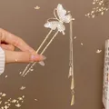 Golden butterfly hair pin with dangling metal tassels and sparkling white rhinestones - Butterfly Wind Chime