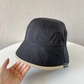 Close-up of black cotton bucket hat featuring beige brim piping and small side label - M(56-58cm) / Black