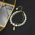 Double-layer natural pearl bracelet with green beads and a gold feather pendant charm - Green Jade Double Layer Feather Bracelet