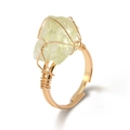 Handmade gold wire-wrapped ring featuring an irregular light green raw gemstone - Citrine