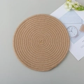 Handwoven round jute placemat in natural brown finish for dining table heat protection - Flaxen