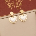 Elegant gold heart earrings with white pearl inlay and engraved Love lettering detail - Gold Heart Mother of Pearl Earrings