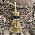 Handmade mini witch broom charm with golden moon pendant on natural wood background - Hollow Moon Gold