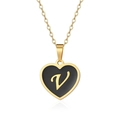 Macro detail of a golden heart pendant with black enamel finish and gold letter V engraving - Style Letter V