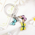 Detail of metal keychain featuring colorful blue pink and yellow butterfly pendants - Style 2 M740 (Blue/Pink/Yellow Butterfly)