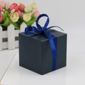 Deep blue square gift box with matching silk ribbon and bow on white surface - Navy Blue