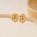 Close-up of gold plated huggie earrings featuring double row pavé white cubic zirconia - EH411004