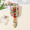 Detail of detangling hairbrush featuring a floral Highland cow print on a light background - Style B