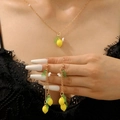 Summer lemon jewelry set with gold chain necklace and floral tassel earrings on model - Lemon Necklace and Earrings Set (G-187)