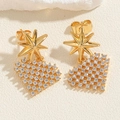 Macro detail of gold-plated star and heart-shaped stud earrings with zircon stones - White Heart (ES2308-4)