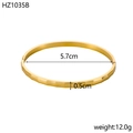 Detailed view of faceted 18K gold plated cuff bracelet with 5.7cm diameter and dimensions - Inner Diameter 5.7cm Width 0.5cm / Gold (Facetted)