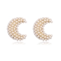 Macro view of gold-plated crescent moon earrings encrusted with lustrous white pearls - Gold Moon