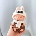 Labubu doll accessory featuring a white bunny hat and brown overalls on a blue cloth - Bear Plaid Outfit / First And Second Generation Keychains Are Compatible With La Cloth Dolls. Dolls Not Included.