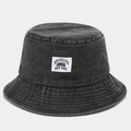 Detail view of washed cotton bucket hat showing fabric texture and Brooklyn cloth label - One Size / Black