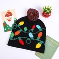 Detail of the LED knit Christmas hat featuring colored bulb patterns and a power switch - Black With Color Lamp String