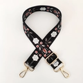 Detail of ethnic floral embroidery on black webbing bag strap with gold metal hardware - Black Ethnic Embroidery / Gold Buckle