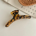 Detail of a large leopard print hair claw clip in tortoiseshell resin for women styling - Dark Leopard Print